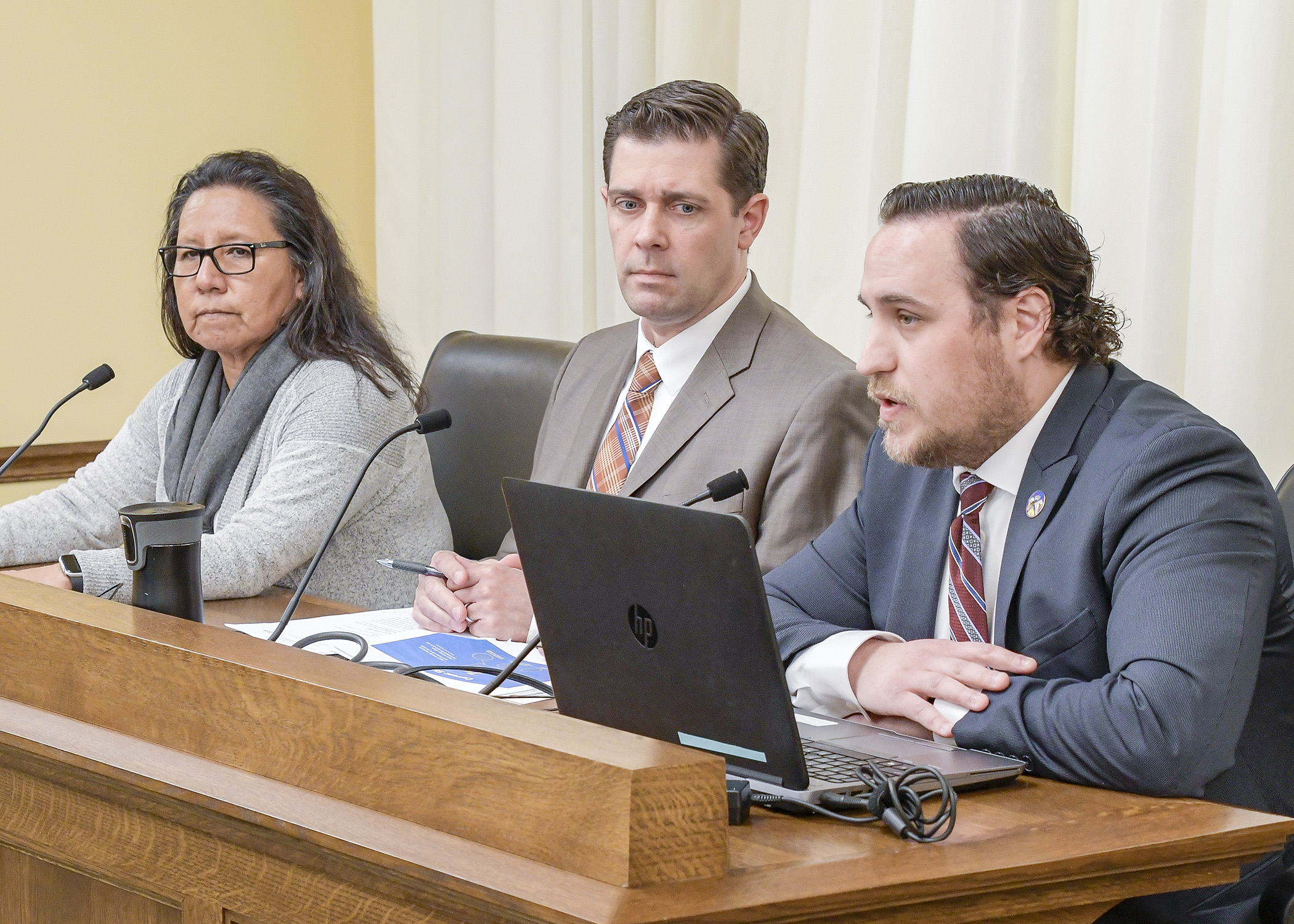 Blake Johnson, government relations specialist at the Prairie Island Indian Community, testifies March 5 for a bill sponsored by Rep. Andrew Carlson, center, to establish a net zero energy emissions project. Photo by Andrew VonBank